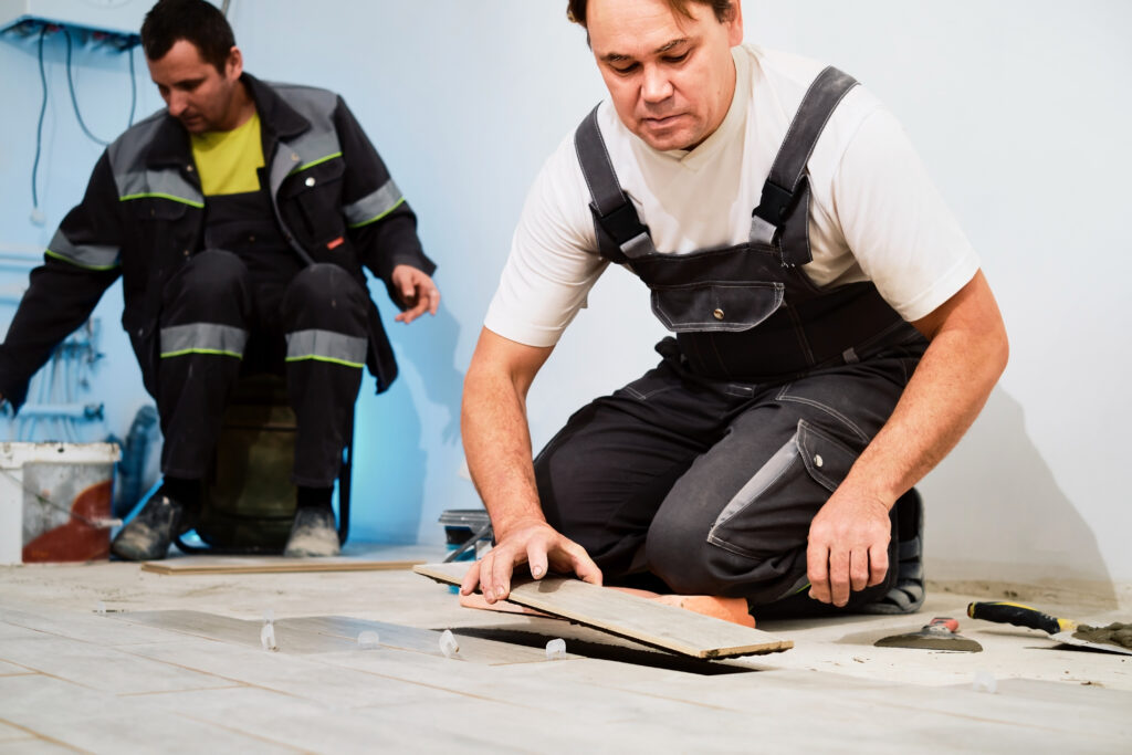 a man fixing tile